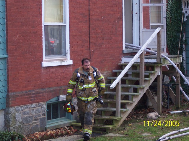 Firefighter Mike Nelson exits a house fire on Pine Street.