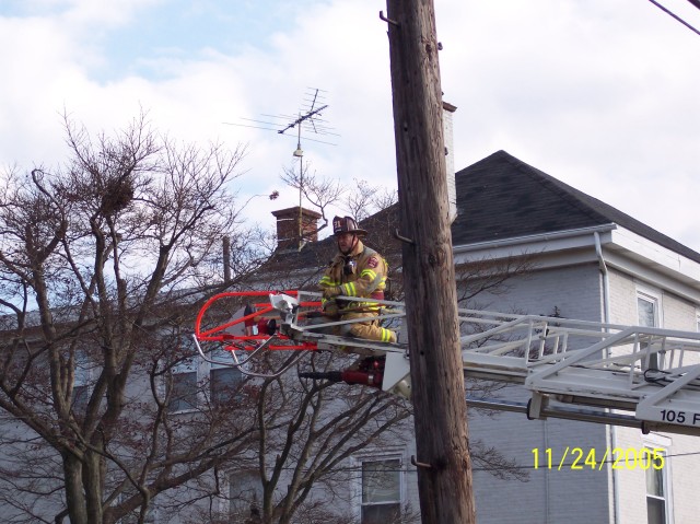 Past Chief Allen Fowler on the tip of Ladder 21 on a Pine Street house fire.