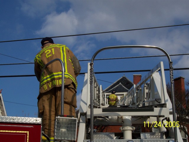 Firefighter Dave Vining moves Ladder 21 into position.