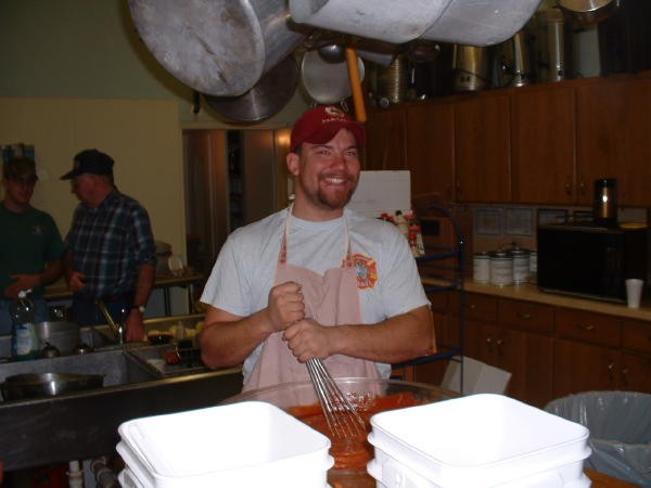 Bill Gray mixing the cocktail sauce at a Ham & Oyster dinner.