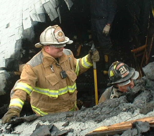 Chief Obenchain and Firefighter Randy Gray working a house fire.