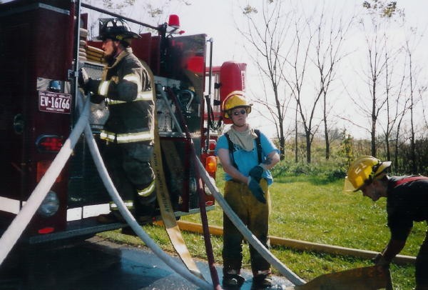 Firefighters Chris Cloud and Adam Weaver assist with racking the lines at a Reedville Road house fire.