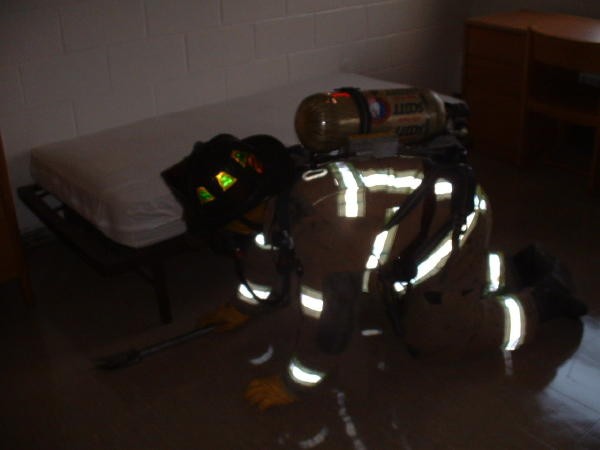 Firefighter Dan Murray searching a dorm room at Lincoln University.