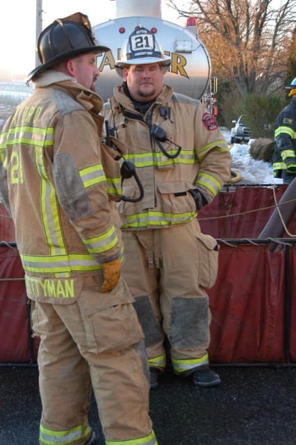 Bob Prettyman and Sam Terry running the water supply at a Rising Sun building fire.