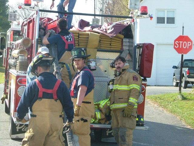 Crews racking a handline after a car fire on Penns Grove Road.