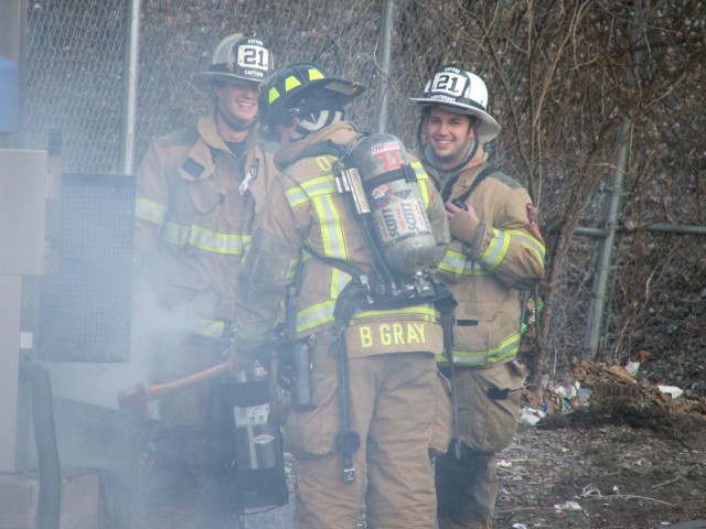 Win Slauch, Bill Gray, and Brian Kelley at a working trash can fire at the car wash on Lincoln Street.