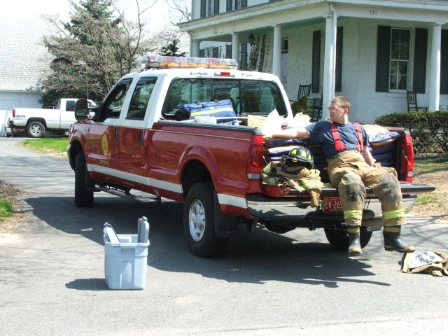 Firefighter Scott Wisner sitting on Squad 21 at crash in Nottingham.