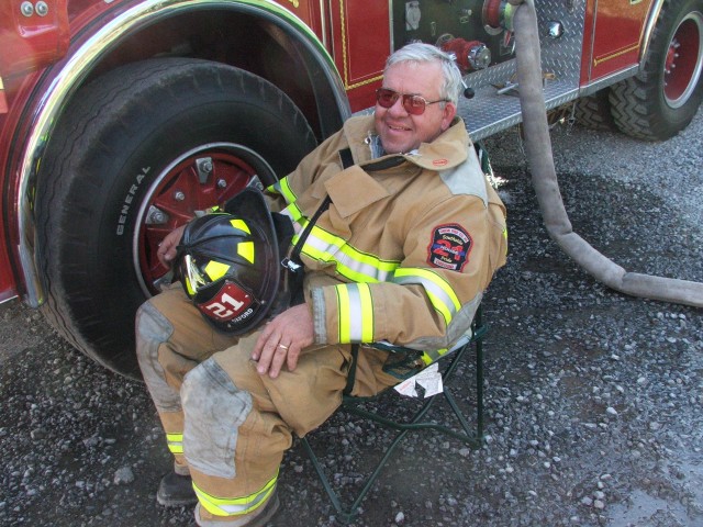 Past Chief Jim Prettyman taking advantage of a folding chair at a barn fire on Homeville Road.