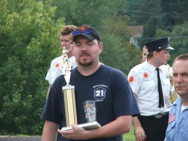 Firefighter Terry Rivera with a trophy.