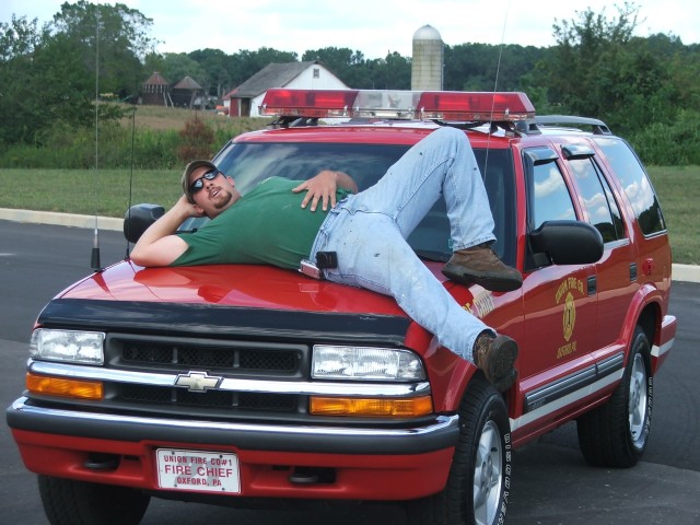 Firefighter Randy Gray chilling on the old Chief's buggy.