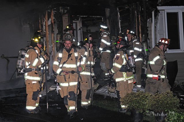 Captain Bob Prettyman comes out of the house at a Rising Sun fire.