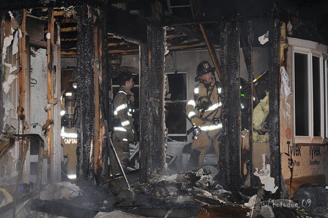 Firefighter Dave McCormick hooking some drywall at a Rising Sun fire.