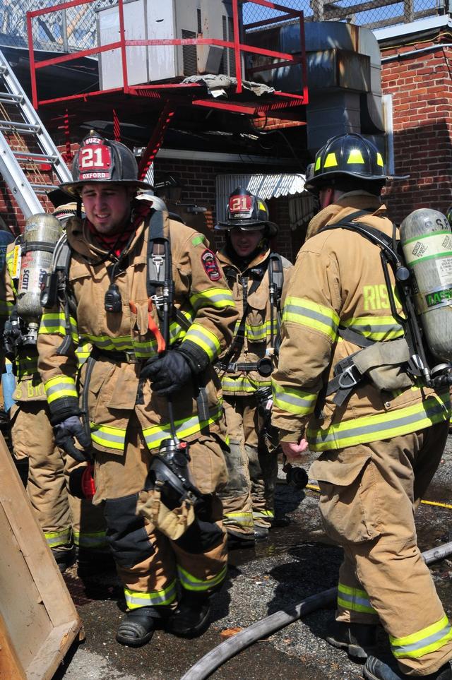 Firefighters Brian Slauch and Matt Groseclose exit the fire building.