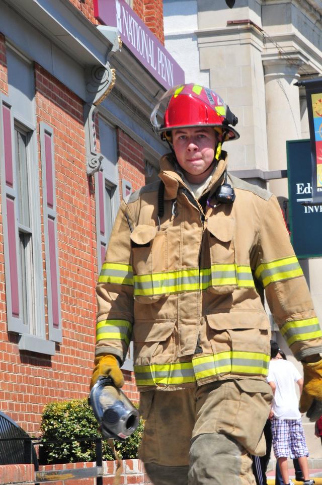 Junior Firefighter Brendan McNair walking down Third Street.