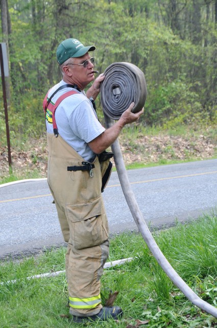 Past Chief Rich Terry rolling hose.