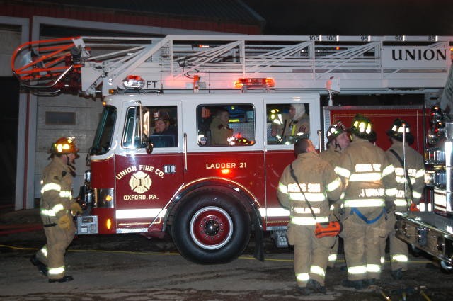 Frank Hersh backs Ladder 21 into position at a Rising Sun fire.