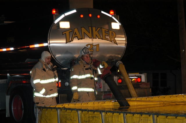 Mark Vining and Rich Terry running water supply at a barn fire.