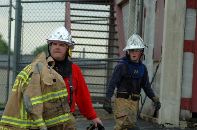 Firefighters John Poole and Andy McCullin preparing for a day of training.