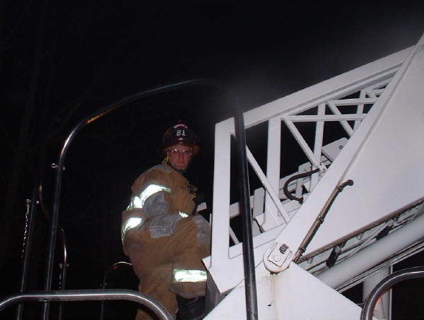 Past Chief Allen Fowler operating Ladder 21 at a chimney fire on Kirkwood Pike.