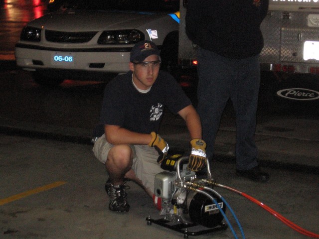 Firefighter Brian Slauch operates on the portable Hurst motors.