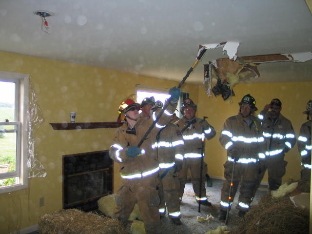 Junior Firefigther Matt Groseclose hooking some ceiling.