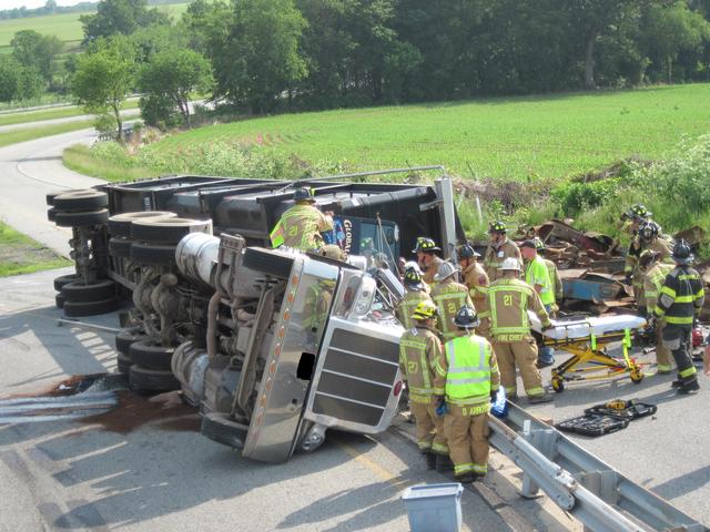 An overturned tractor trailer with a subject trapped on the northbound Route 1 off ramp to Route 10.