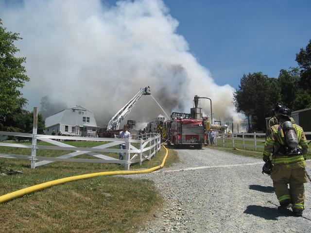 Firefighters Andy McCullin and Keith Hampton reporting to the scene at a Quarryville barn fire.