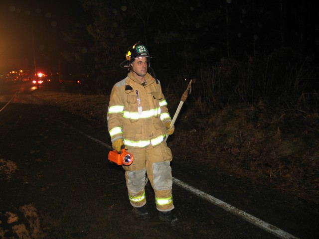 Firefighter Brian Neubauer walks into a scene.