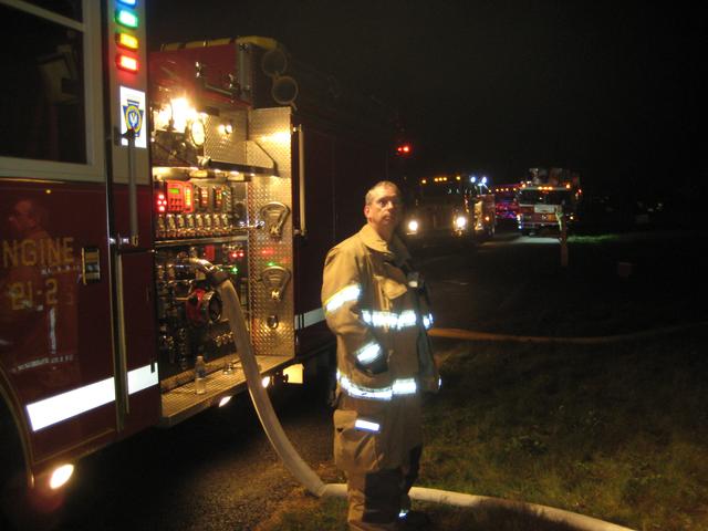 Firefighter Bud Charlton manning the pump of Engine 21-2.