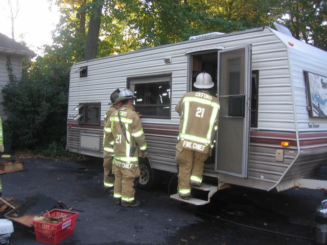 The 2011 Chiefs, Assistant Bob Prettyman, Deputy Brian Kelley, and Chief Mark Vining at a camper fire on Cullen Road.