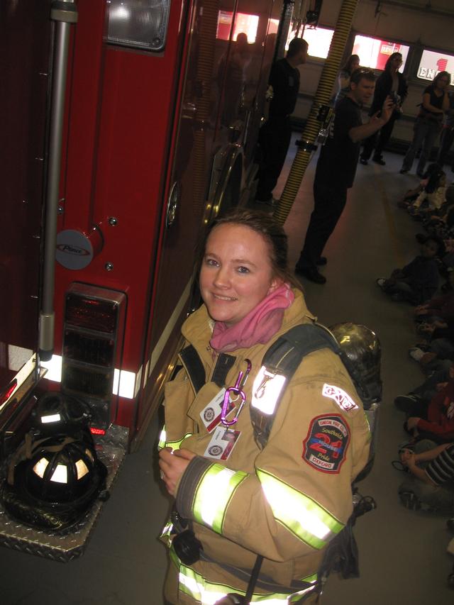 Firefighter Michelle Smith gearing up a Fire Prevention detail.