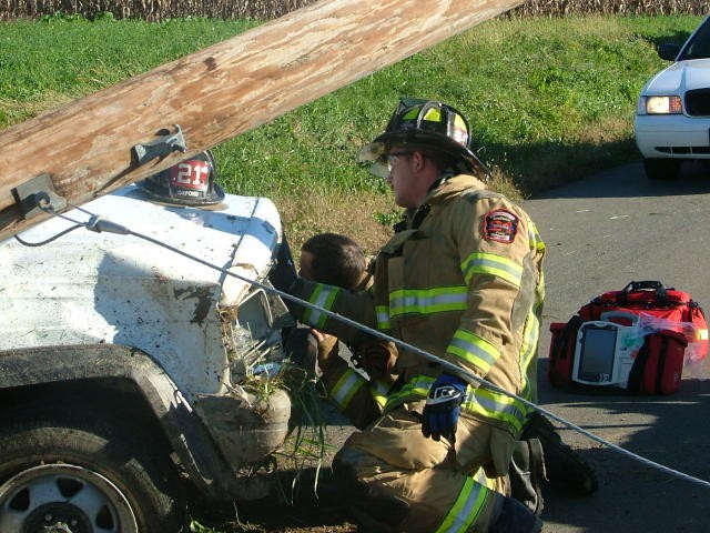 Randy Gray and Win Slauch securing a vehicle at a crash on Penns Grove Road.