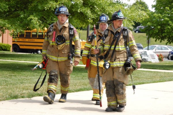 Firefighters Scott Wisner, Brian Parisan, and Greg Paxson at a building fire at the Rising Sun High School.