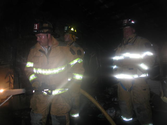 Firefighter Alan Haines hitting some hot spots at fire in Cochranville.