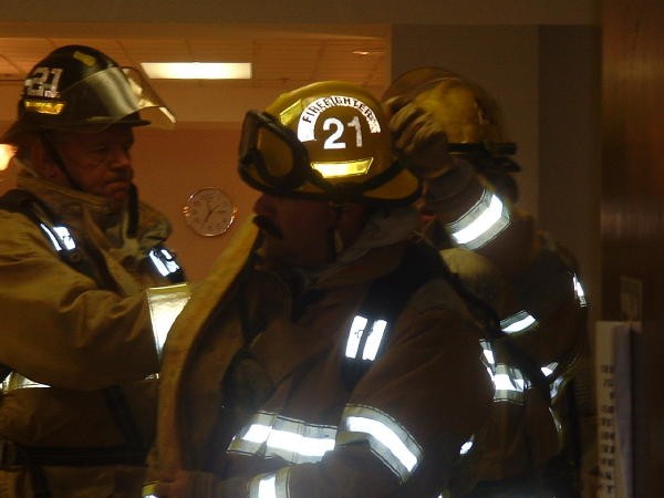 Firefighter Luke Harshbarger running a line into Ware.