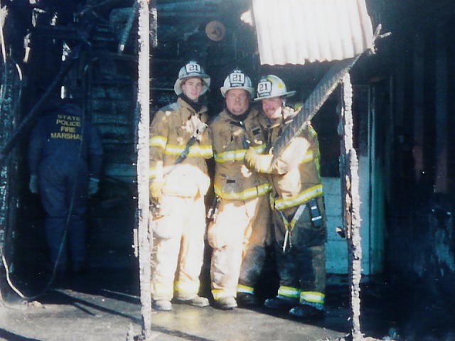 Lieutenant Win Slauch, Captain Sam Terry, and Captain Bill Gray at a building fire at the old &quot;Potato Barn&quot; on Lincoln Street.