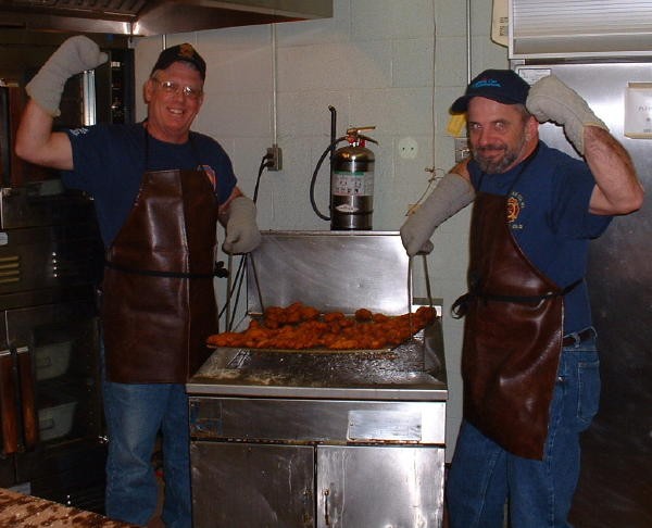 Past Chief Rich Terry and Firefighter Steve Gray cooking oysters.