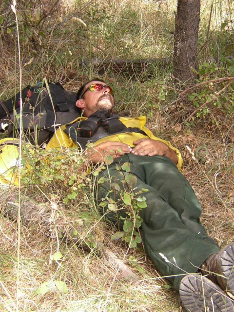 Firefighter Mike Nelson catching some rest during a large brush fire out west.