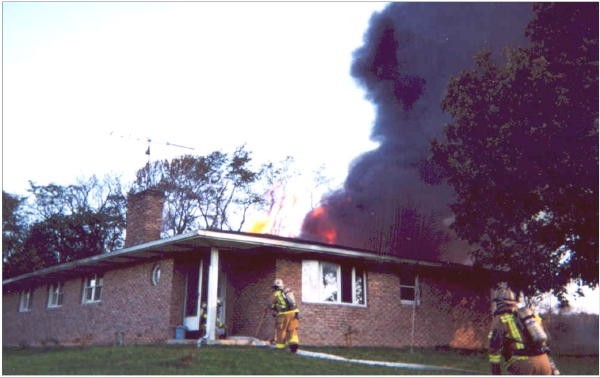 West Grove firefighter Mike Rochester, Deputy Chief Chris Obenchain, and Captain Sam Terry prepare the first interior line on a Reedville Road house fire.