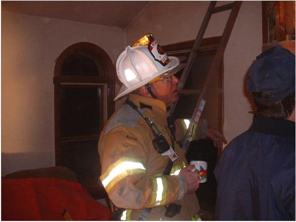 Chief Terry enjoying his coffee at a chimney fire.