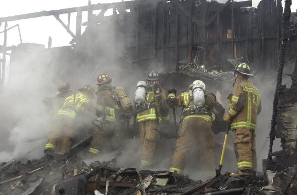 The crews overhauling at a fatal Rising Sun house fire.