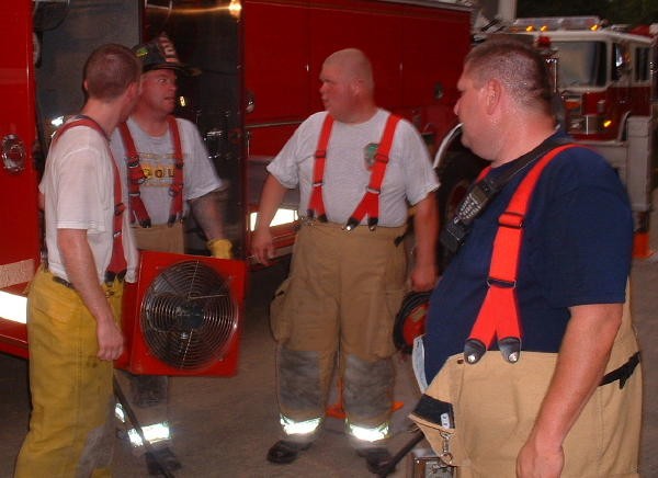 Firefighter Dan Murray pulls a fan off the Truck.