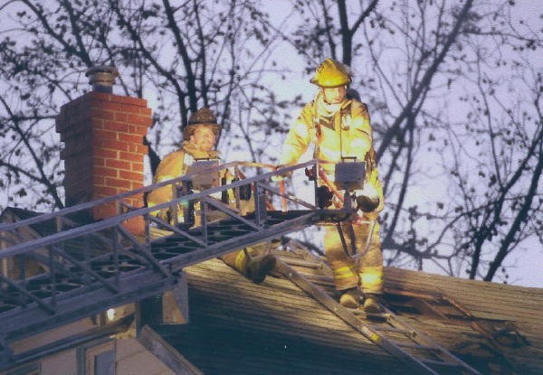 Bill Gray and Richard Carroll on the roof of a North Third Street house fire.